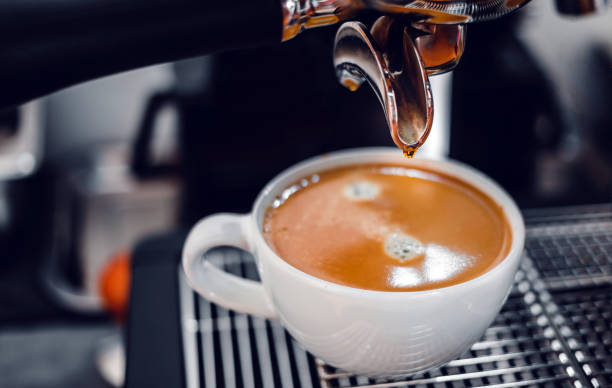 istock Coffee extraction from the coffee machine with a portafilter pouring coffee into a cup,Espresso poruing from coffee machine at coffee shop 1432861371