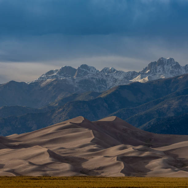 istock Majestic Mountains with Dunes and Brown Field 1432864167