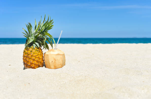 istock Pineapple and coconut drink on white sand background 1432864235