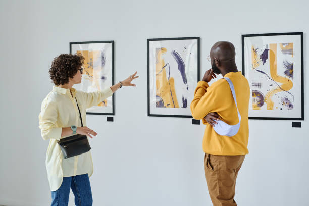 istock Woman discussing art with man 1432866430
