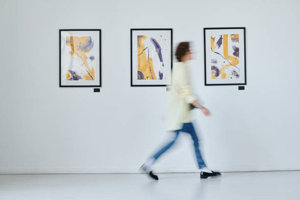istock Young woman walking at art gallery 1432866484