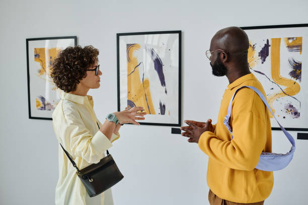 istock Young people discussing pictures together 1432866501