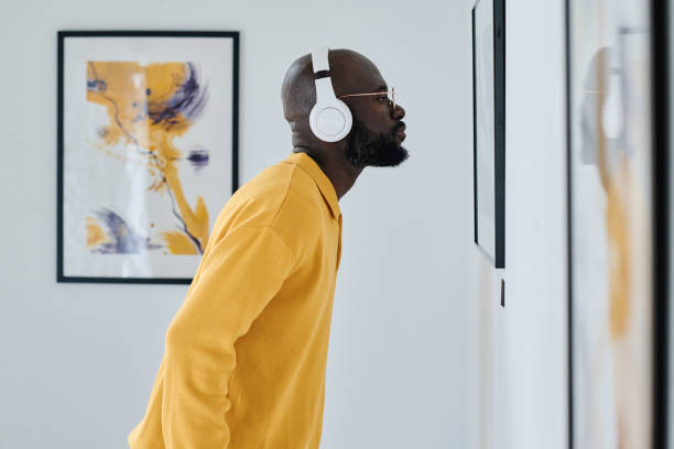 istock African man in headphones visiting art gallery 1432866514