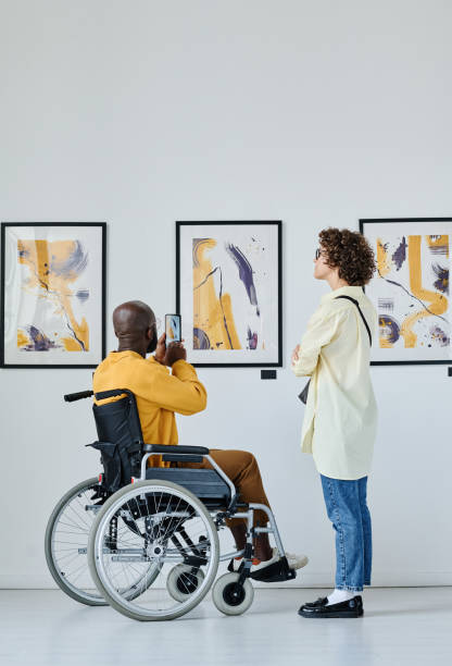 istock Man with disability making photo at gallery 1432866533