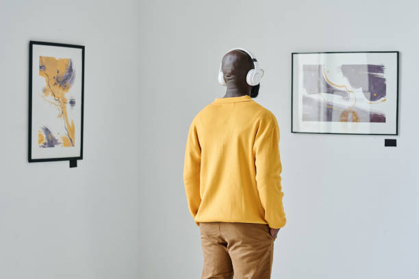 istock Man listening to guide at art gallery 1432866609