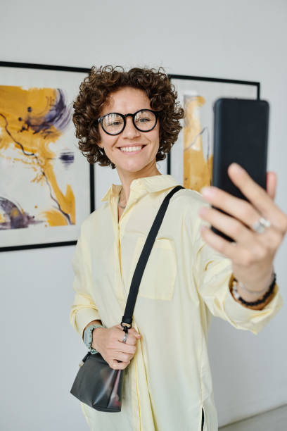 istock Woman taking selfie at art gallery 1432867124