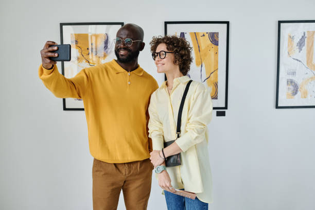 istock Young couple taking selfie at art gallery 1432867197