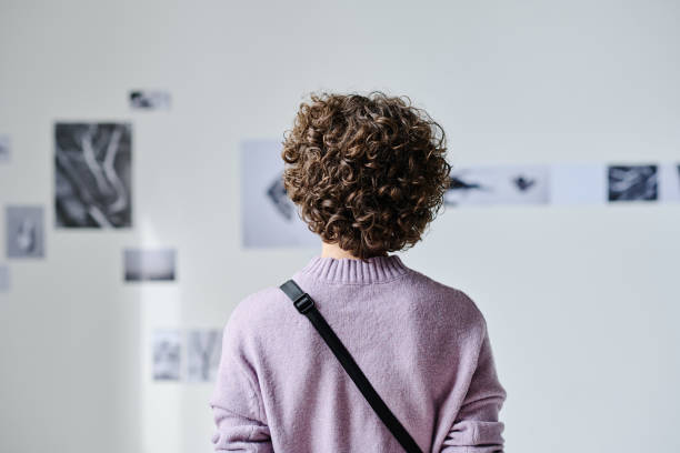 istock Young woman visiting photo gallery 1432867677