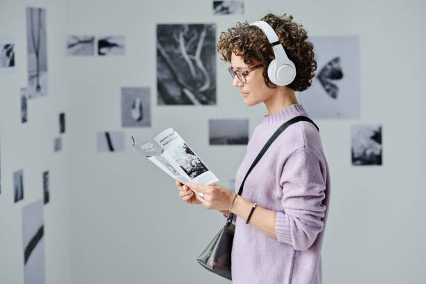 istock Woman reading booklet at gallery 1432867811