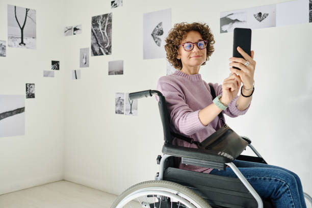 Woman with disability taking selfie portrait at gallery