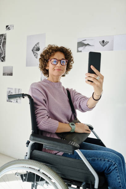 istock Woman with disability taking selfie on smartphone 1432868114