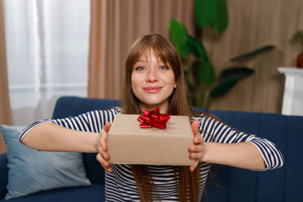 istock Birthday girl with a present at home 1432875000