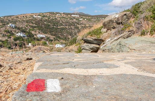 Red and white symbol designating a pedestrian trail on Sifnos island in Greece