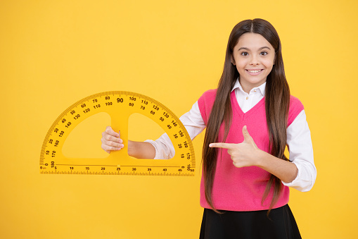 you need this. measuring angle degree. measurement. happy teenage girl showing protractor. back to school. trigonometry stationery. kid study mathematics. stem disciplines. education for child.