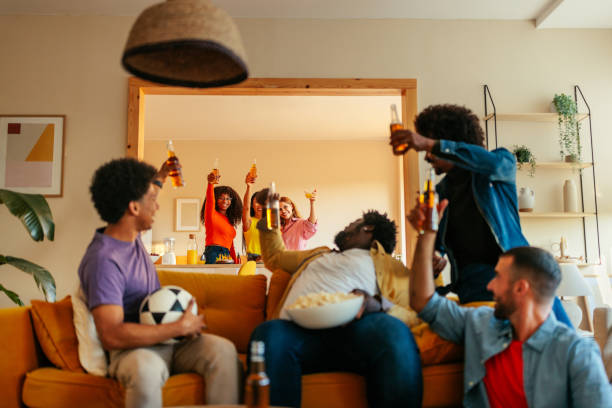 istock Friends watching soccer and toasting with drinks. 1432879356