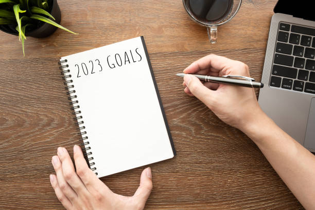 istock Man is writing 2023 goals for new year resolutions plan. 1432879887