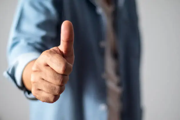 Photo of Man thumbs up showing satisfaction