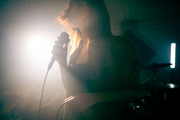 istock Young woman singing at the music studio 1432880775