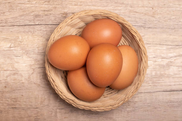 istock Chicken eggs in bamboo basket on wooden background 1432881051