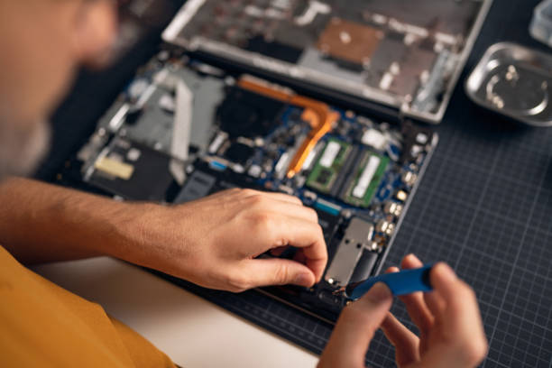 istock Unrecognizable man with screwdriver repairing his laptop 1432883215