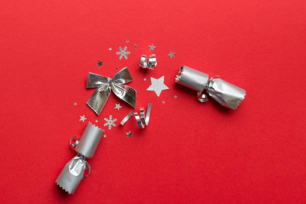 istock Christmas crackers with shiny confetti on color background, top view, copy space 1432886061