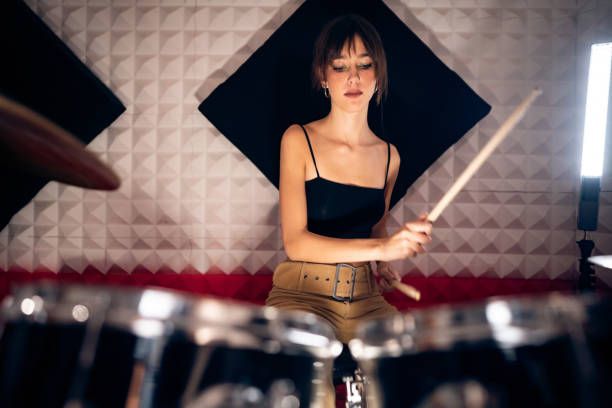 istock Caucasian female drummer, playing drums at the recording studio 1432886521