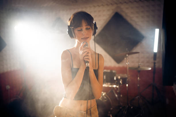 istock Caucasian female singer singing, during rehearsal at the studio 1432888194