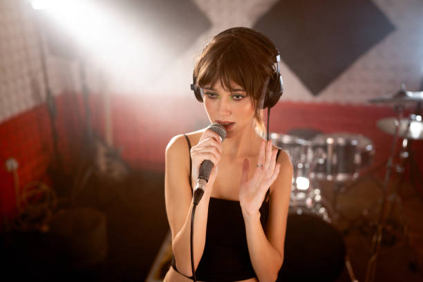 istock Young woman singing, during rehearsal at the studio 1432889010