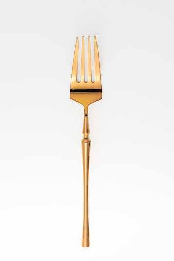 Golden fork isolated on white background.