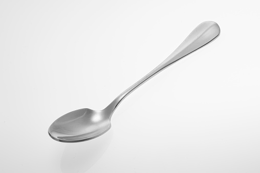 Silver spoon isolated on white background. Studio shot.