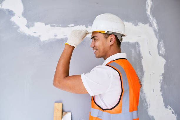 istock Portrait of an Asian construction worker tipping his hat facing left 1432891152