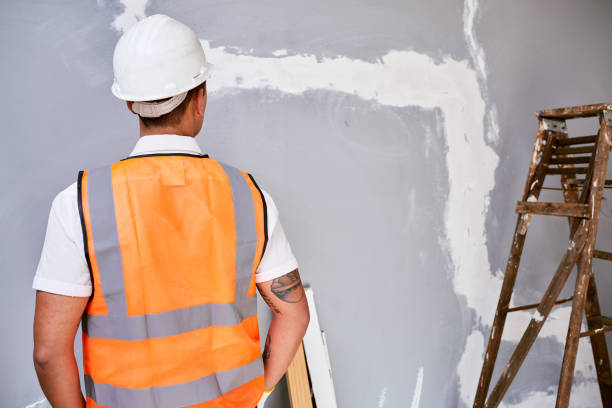 istock The back of a construction worker in uniform as he faces work in progress 1432891176