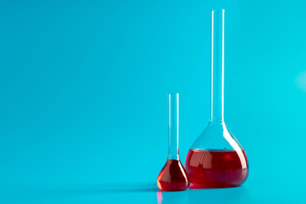 test tubes with red liquid in laboratory on blue background