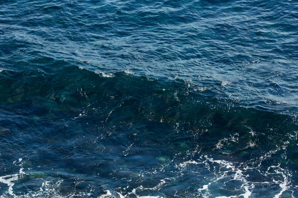 istock Deep blue sea water with spray 1432893639