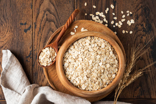 istock Rolled oats, oat flakes in wooden bowl 1432894585
