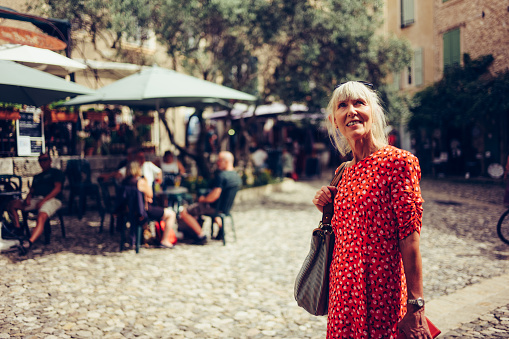 Woman exploring the village of Moustiers Ste-Marie in the Provence region of France.