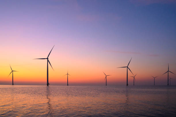 istock Wind turbines in an offshore wind park producing electricity during sunset. 1432896356