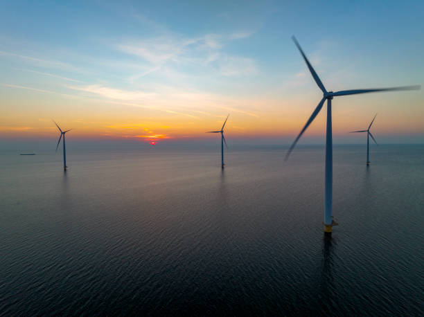istock Wind turbines in an offshore wind park producing electricity during sunset. 1432896842