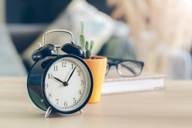 istock Morning sun. Alarm clock on a beautiful background 1432898530