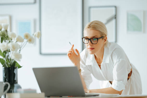 Serious Business Woman Using A Laptop Computer At Work