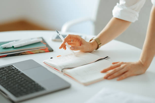 istock Close Up Photo Of Woman Hands Writing Notes In A Notebook At Work 1432899305