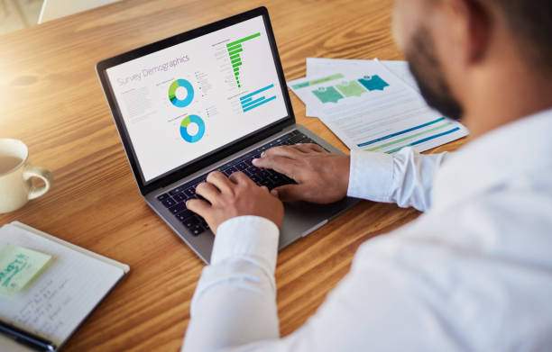 istock Business man planning with finance graph on laptop at work, working on stats and data and doing marketing research in office. Professional worker typing on computer and reading information online 1432899855