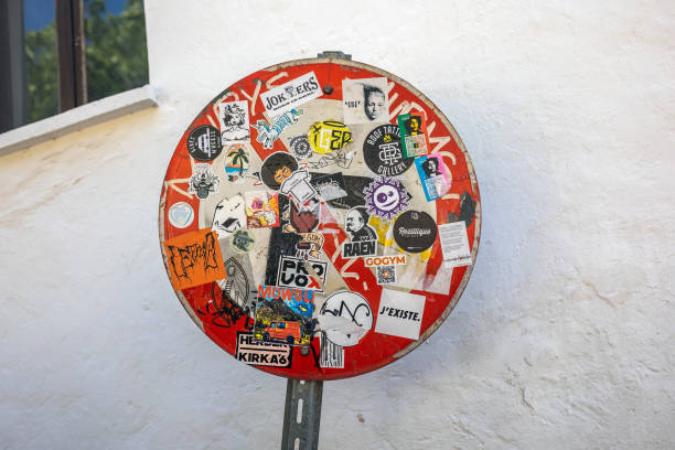 Street sign with stickers at the old streets in the Kas Town. Kas Town is popular tourist travel attraction in Turkey. Kas, Turkey - May 06 2022.