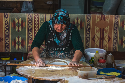 Process of making a traditional Turkish bread. It is made of flat bread stuffed with meat or cheese and baked on sheet iron or pan. Baked in a pan called a saj. Pamukkale, Turkey - October 07 2020.