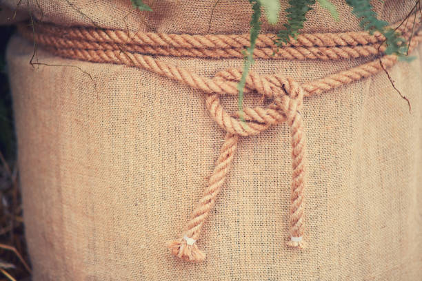 A large canvas bag and a rope with a knot, background