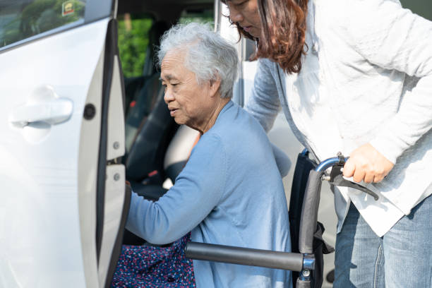 Asian senior or elderly old lady woman patient sitting on wheelchair prepare get to her car, healthy strong medical concept. Asian senior or elderly old lady woman patient sitting on wheelchair prepare get to her car, healthy strong medical concept. senior adult car nurse physical impairment stock pictures, royalty-free photos & images