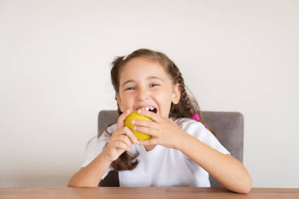 istock Cute girl eating apple 1432902781