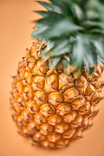 Fresh pineapple isolated on yellow background.