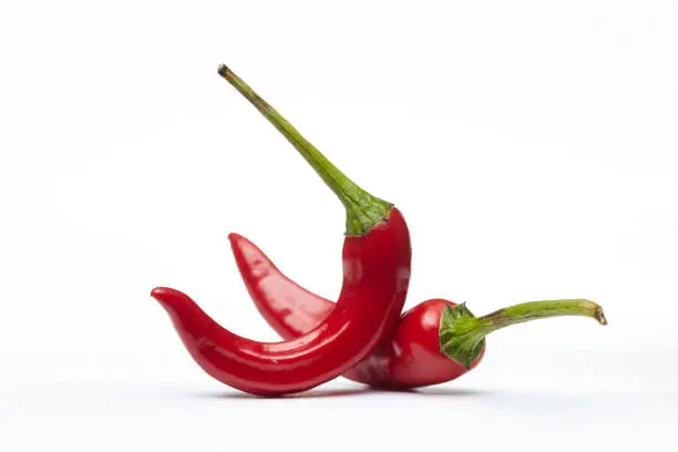 Photo of Red hot chili pepper on old white background