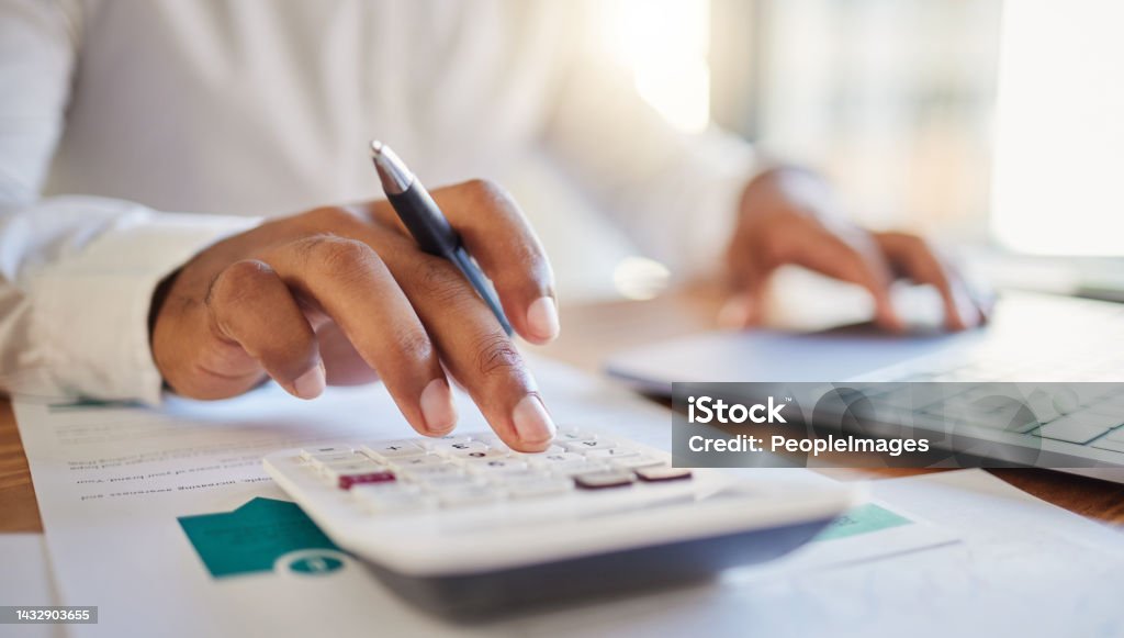 Finance, accounting and fintech, a man on a computer and calculator working out his business budget strategy. Businessman at his office desk, laptop, money management and financial investment online. Finance Stock Photo